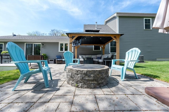 rear view of property with a fire pit, a patio area, roof with shingles, and a gazebo