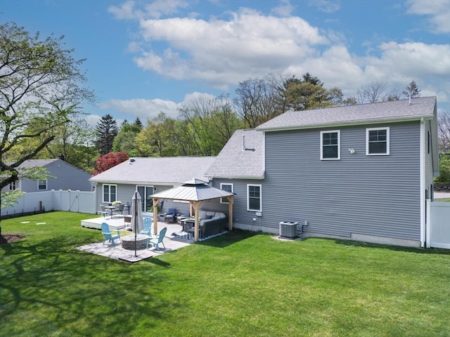 back of house featuring a gazebo, a fire pit, central AC, a patio, and a fenced backyard