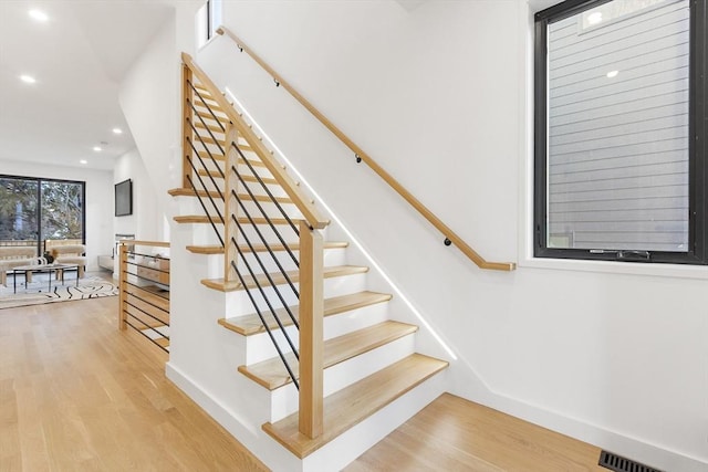 stairway featuring hardwood / wood-style floors