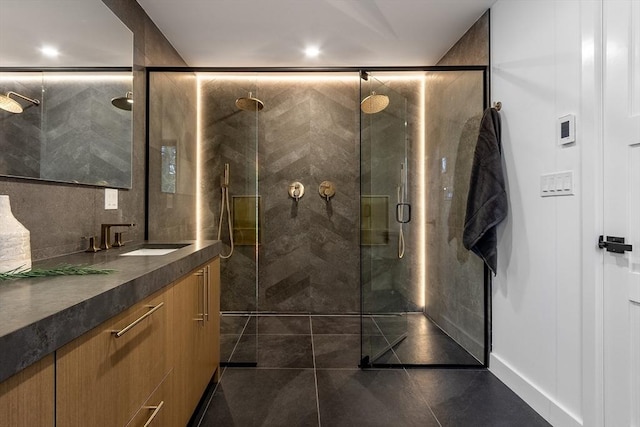 bathroom with vanity and a shower with door