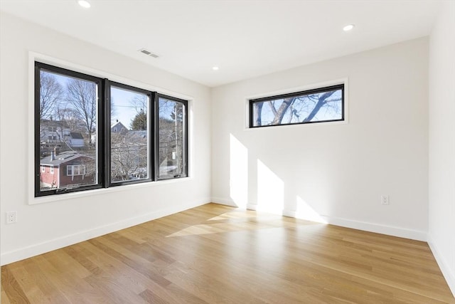 spare room with plenty of natural light and light wood-type flooring