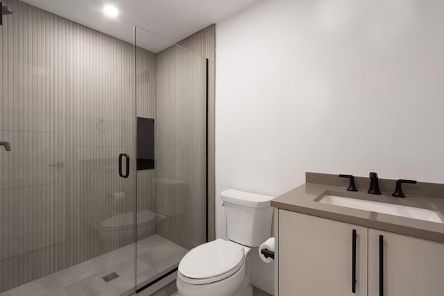 bathroom featuring vanity, an enclosed shower, and toilet