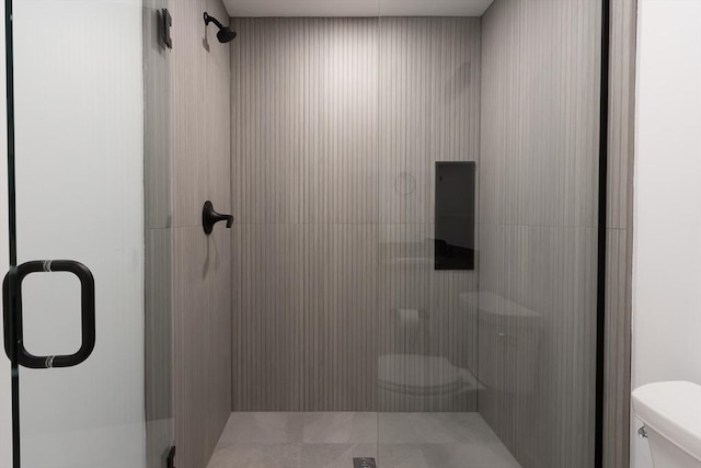 bathroom with toilet and an enclosed shower