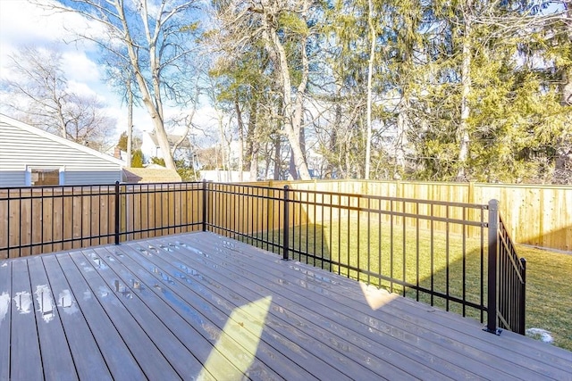 wooden deck featuring a lawn