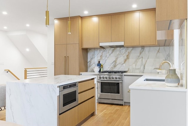 kitchen with appliances with stainless steel finishes, sink, light brown cabinetry, and light hardwood / wood-style floors