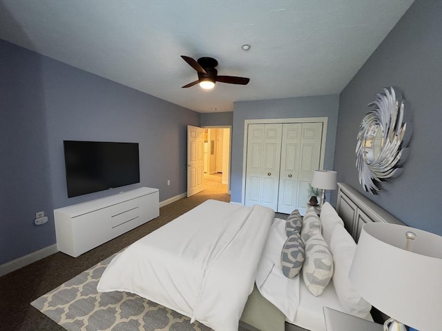 carpeted bedroom with baseboards, a closet, and ceiling fan
