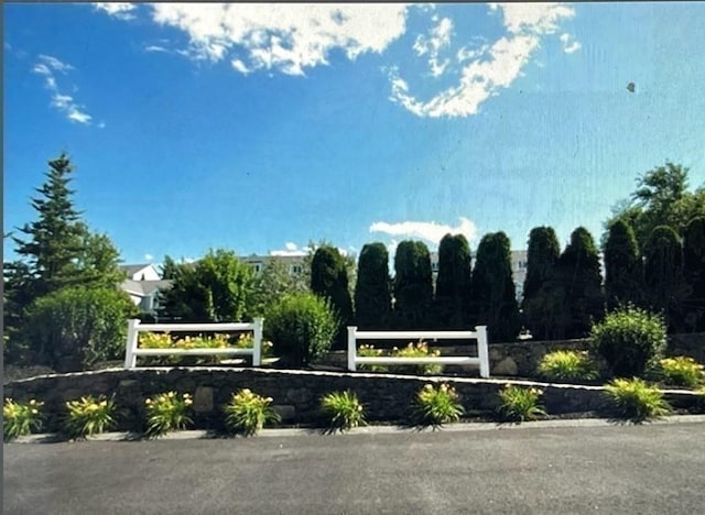 community sign featuring fence