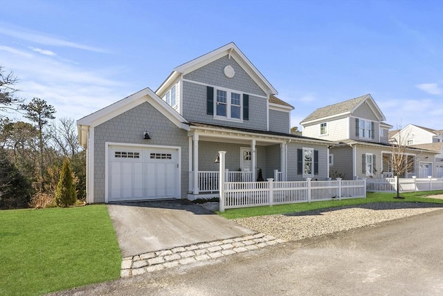 view of front of house with a porch, a front yard, fence, a garage, and driveway