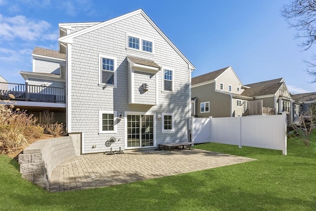 back of property with a yard, a patio area, and fence