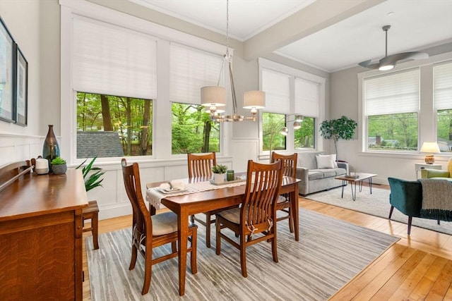 sunroom featuring plenty of natural light and a chandelier