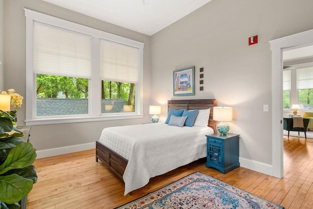 bedroom with baseboards and hardwood / wood-style flooring