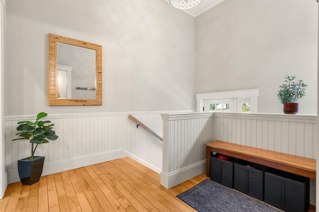 stairs with a wainscoted wall and hardwood / wood-style floors