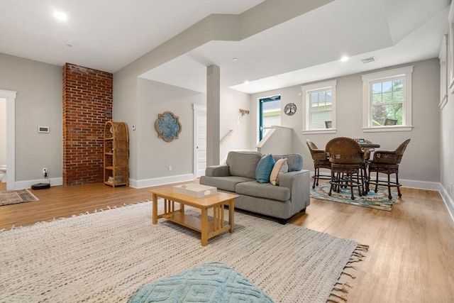 living area with wood finished floors, baseboards, and recessed lighting