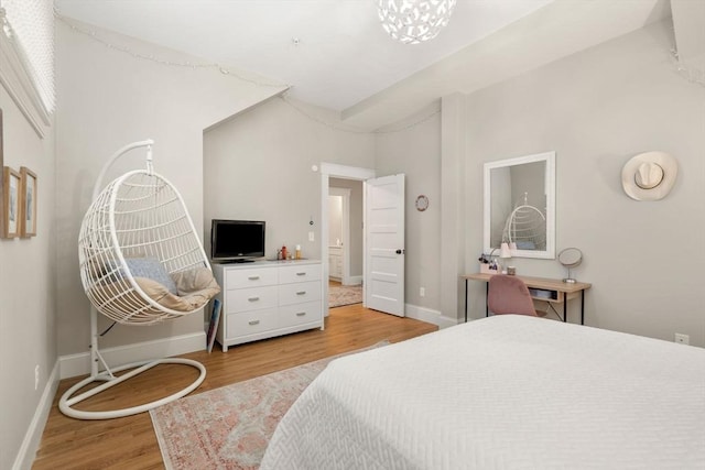 bedroom with light wood finished floors and baseboards