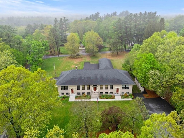 view of subject property featuring a heavily wooded area