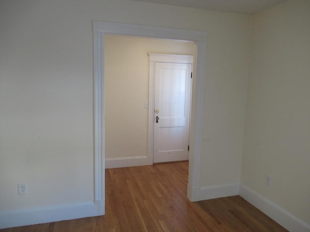 hallway with hardwood / wood-style floors