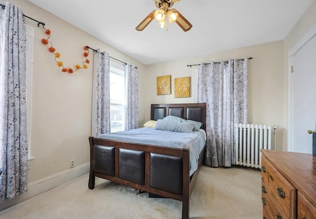 carpeted bedroom featuring radiator heating unit and ceiling fan