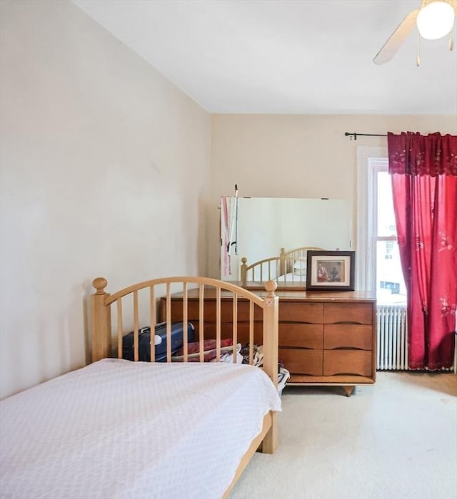 bedroom featuring ceiling fan and radiator heating unit