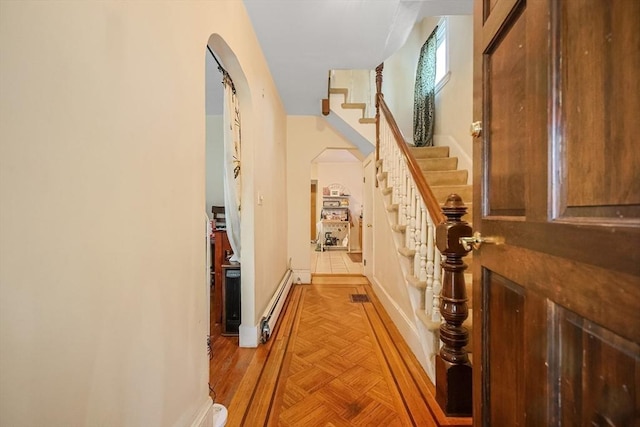 hall featuring light parquet flooring and a baseboard heating unit