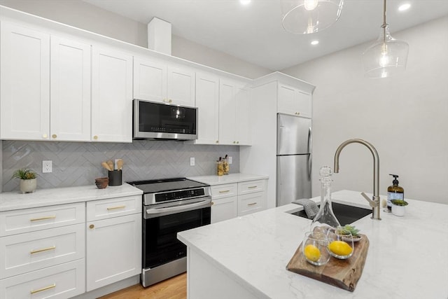21 Ellington St Unit 2, Boston, MA 02121 - kitchen featuring appliances with stainless steel finishes, a sink, white cabinetry, recessed lighting, and backsplash