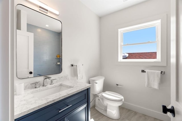 21 Ellington St Unit 2, Boston, MA 02121 - bathroom featuring vanity, baseboards, toilet, and wood finished floors