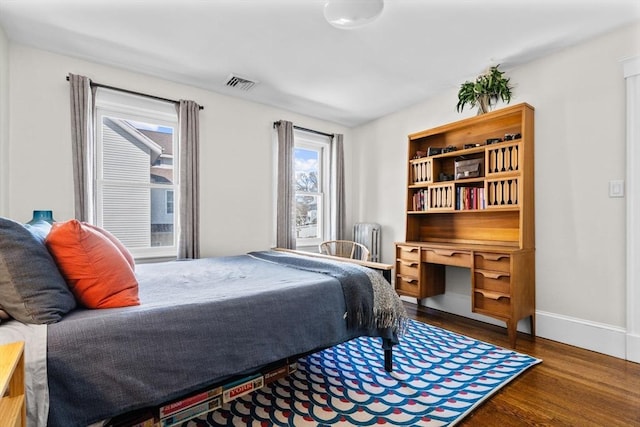 149-151 Pleasant St, Watertown, MA 02472 - bedroom featuring radiator, wood finished floors, and baseboards