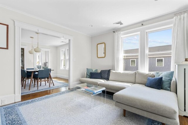 149-151 Pleasant St, Watertown, MA 02472 - living area with ornamental molding, baseboards, and wood finished floors