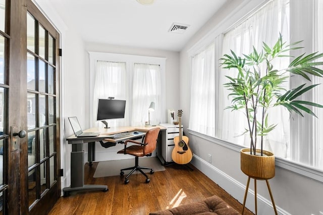 149-151 Pleasant St, Watertown, MA 02472 - home office with wood finished floors, healthy amount of natural light, french doors, and baseboards
