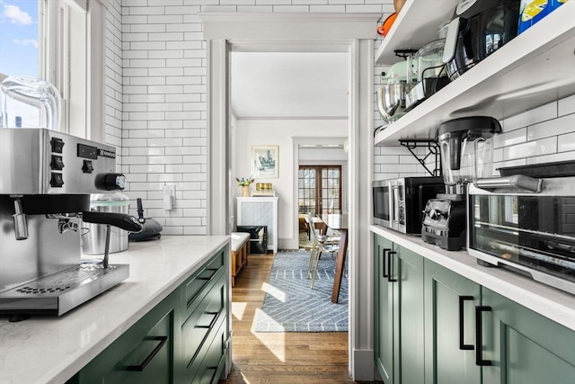 149-151 Pleasant St, Watertown, MA 02472 - kitchen with green cabinets, open shelves, wood finished floors, and tasteful backsplash