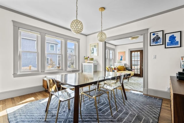 149-151 Pleasant St, Watertown, MA 02472 - dining room featuring plenty of natural light, dark wood-style flooring, baseboards, and crown molding