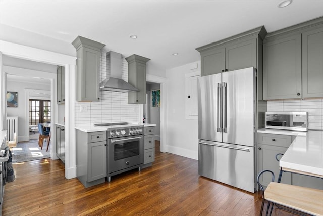 149-151 Pleasant St, Watertown, MA 02472 - kitchen featuring premium appliances, wall chimney exhaust hood, gray cabinets, light countertops, and recessed lighting