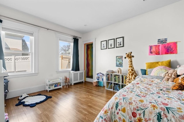 149-151 Pleasant St, Watertown, MA 02472 - bedroom featuring wood finished floors, radiator, and baseboards