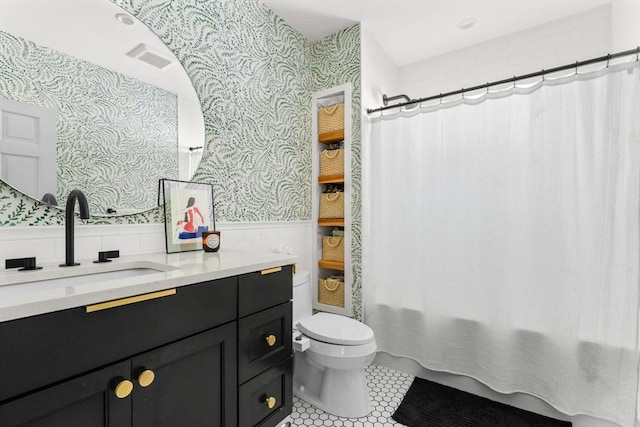 149-151 Pleasant St, Watertown, MA 02472 - bathroom featuring wallpapered walls, wainscoting, toilet, vanity, and tile patterned floors