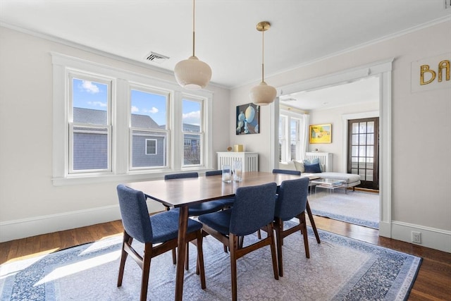 149-151 Pleasant St, Watertown, MA 02472 - dining area featuring crown molding, wood finished floors, and baseboards