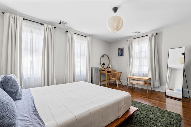 149-151 Pleasant St, Watertown, MA 02472 - bedroom featuring wood finished floors and radiator heating unit