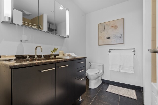 bathroom featuring vanity, toilet, and tile patterned floors