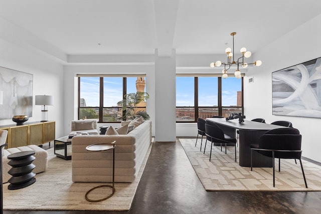 living room with a chandelier and concrete floors