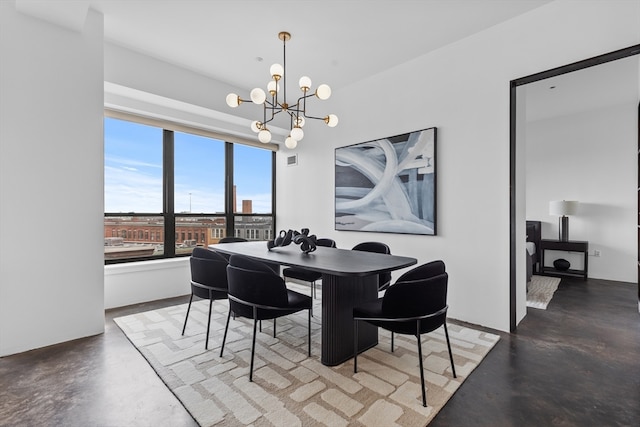 dining space with an inviting chandelier and concrete floors