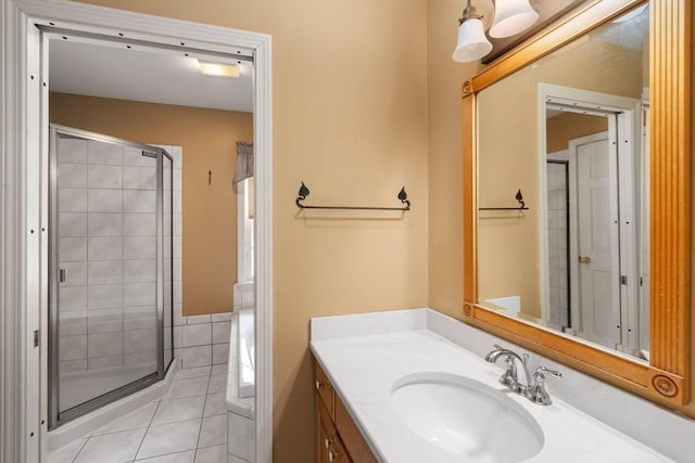 bathroom with vanity, tile patterned floors, and a stall shower