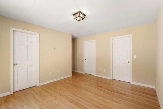 unfurnished bedroom featuring baseboards and light wood-style flooring