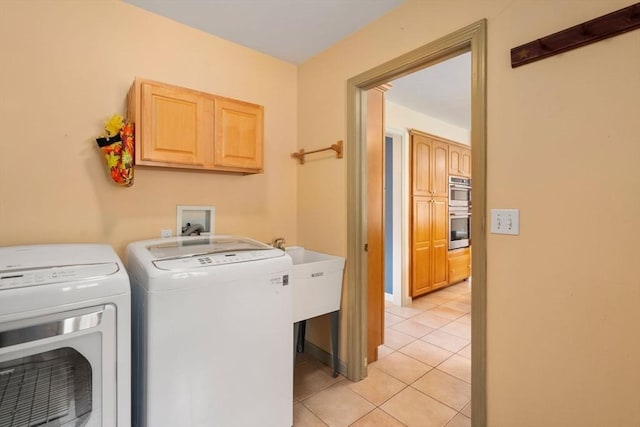 washroom featuring separate washer and dryer and light tile patterned floors