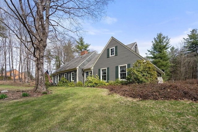 view of front facade with a front lawn and a chimney