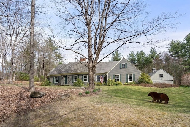 view of front of home with a chimney and a front lawn