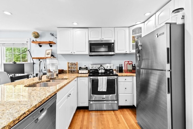 13 Emmet St Unit 1, Boston, MA 02127 - kitchen featuring appliances with stainless steel finishes, a sink, recessed lighting, light wood-style floors, and light stone counters