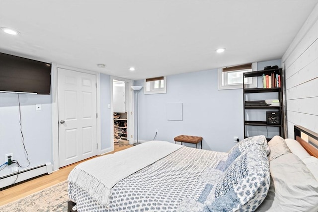 13 Emmet St Unit 1, Boston, MA 02127 - bedroom with a baseboard heating unit, light wood finished floors, and recessed lighting