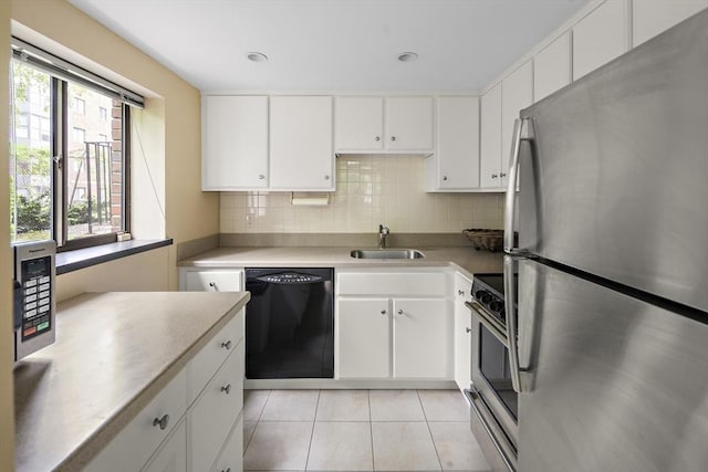 993 Massachusetts Ave Unit 127, Arlington, MA 02476 - kitchen with stainless steel appliances, a sink, white cabinetry, and light tile patterned flooring