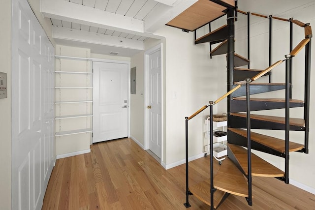 993 Massachusetts Ave Unit 127, Arlington, MA 02476 - hallway with electric panel, wood finished floors, baseboards, stairs, and wooden ceiling with exposed beams