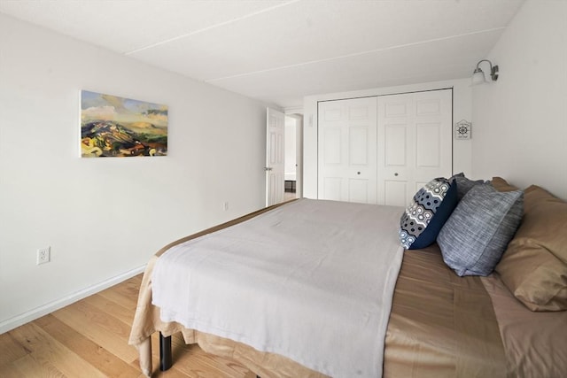 993 Massachusetts Ave Unit 127, Arlington, MA 02476 - bedroom with wood finished floors, a closet, and baseboards