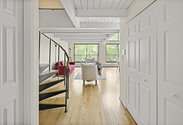993 Massachusetts Ave Unit 127, Arlington, MA 02476 - staircase with wood-type flooring, a baseboard heating unit, and wood ceiling with exposed beams
