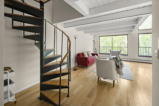 993 Massachusetts Ave Unit 127, Arlington, MA 02476 - stairway with baseboard heating, baseboards, wooden ceiling with exposed beams, and wood finished floors